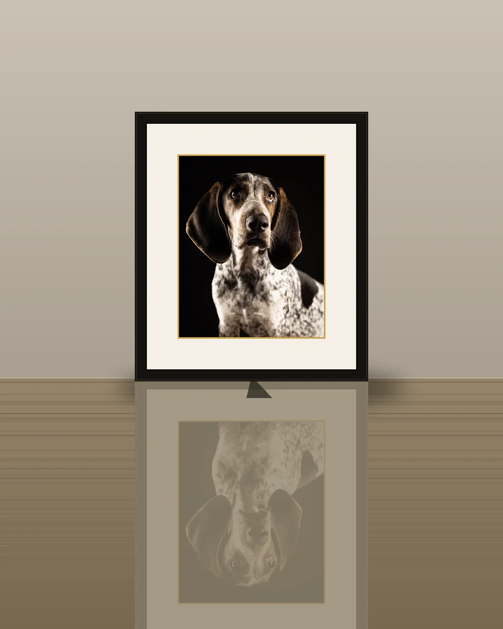 A small framed dog portrait standing as desk art